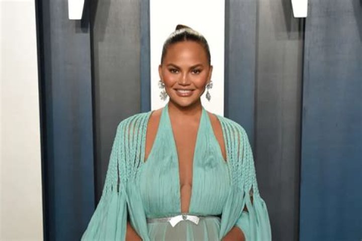 Chrissy Teigen Body-Shamed After Sharing Thirst Trap Vid Of Her In A Plunging Bathing Suit – She Claps Back!