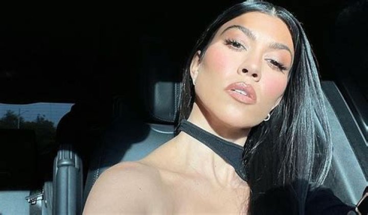 Kourtney Kardashian Strikes A Sultry Pose In Cut-Out Midi Dress