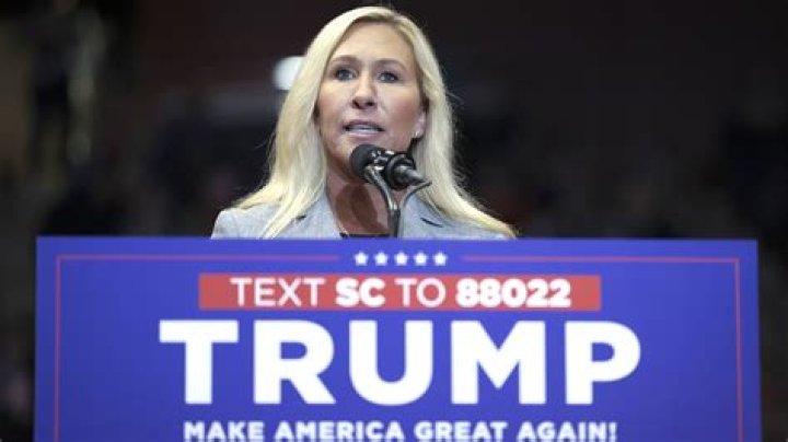 Marjorie Taylor Greene foams at the mouth over Donald Trump sitting in a chair and talking