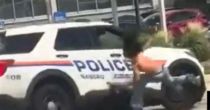 Woman waving gun at traffic knocked down by police car